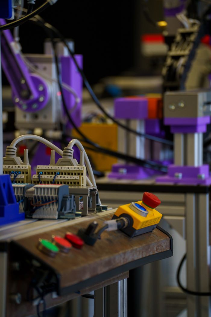 About Close-up of industrial automation setup with control panel and machinery parts.